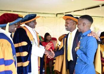 The Deputy Speaker, Thomas Tayebwa (second right) interacting with top university officials and a student (right)