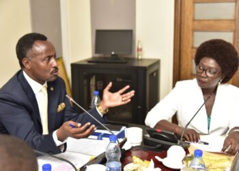 Finance Committee Chairperson, Hon. Amos Kankunda, (left) and the Executive Director UMRA, Ms. Edith Tusuubira, during the committee meeting on Monday 26 February 2024