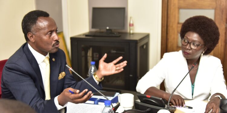 Finance Committee Chairperson, Hon. Amos Kankunda, (left) and the Executive Director UMRA, Ms. Edith Tusuubira, during the committee meeting on Monday 26 February 2024