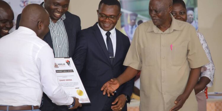 Mr. Busuulwa receiving his award
