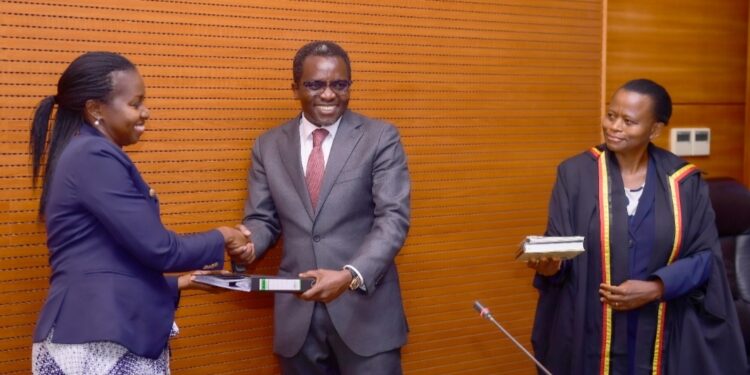 Dr. Omona hands over PSS office to Ms. Asio as Ms. Nakyobe looks on