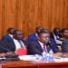 UNRA’s Director for Roads and Bridges, Eng. Samuel Muhoozi (left) leading the UNRA team appearing before COSASE on Wednesday, 13 March 2024