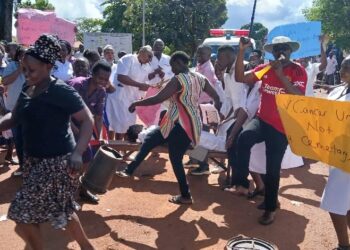 Some female health workers dance provocatively flashing their backs and thighs to the DPC Innocent Mubangizi.