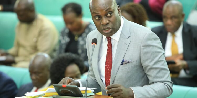 Hon. Fred Opolot, presenting the Committee Report to Parliament