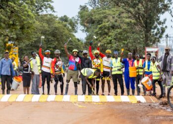 Riders and walkers paint the Jinja main zebra crossing