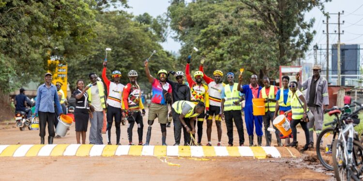 Riders and walkers paint the Jinja main zebra crossing