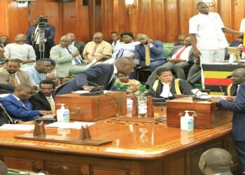 Speaker Among confers with Musasizi as Ssemujju waits to make his contribution