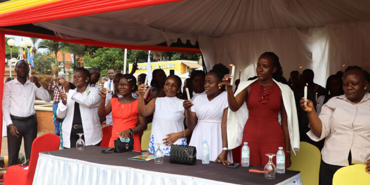 Some of the participants at the International Candlelight Day at the National Records and Archives centre in Kampala on Monday