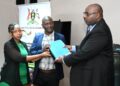 Ministry of Local Government Permanent Secretary Ben Kumumanya (right) handing over the contract to a team from UB Consulting at the Ministry of Local Government Headquarters in Kampala on Wednesday 30 April 2025.