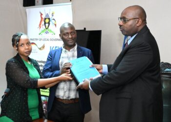 Ministry of Local Government Permanent Secretary Ben Kumumanya (right) handing over the contract to a team from UB Consulting at the Ministry of Local Government Headquarters in Kampala on Wednesday 30 April 2025.