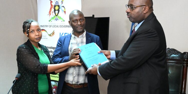 Ministry of Local Government Permanent Secretary Ben Kumumanya (right) handing over the contract to a team from UB Consulting at the Ministry of Local Government Headquarters in Kampala on Wednesday 30 April 2025.