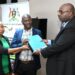 Ministry of Local Government Permanent Secretary Ben Kumumanya (right) handing over the contract to a team from UB Consulting at the Ministry of Local Government Headquarters in Kampala on Wednesday 30 April 2025.