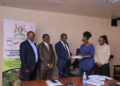 Hajj Sewante handing over the contract to Gloria Sibo Muhwezi of Gesch Consult