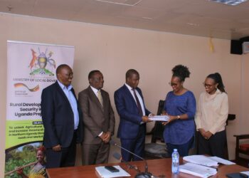 Hajj Sewante handing over the contract to Gloria Sibo Muhwezi of Gesch Consult