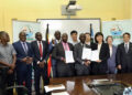 NARO Director General, Dr. Yona Baguma and the Director JAAS, Dr. Yang Yiyang, exchange copies of the MoU after the signing in Entebbe on Monday.