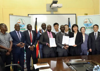 NARO Director General, Dr. Yona Baguma and the Director JAAS, Dr. Yang Yiyang, exchange copies of the MoU after the signing in Entebbe on Monday.
