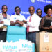 Diana-Ondoga-Stanbic-Bank-Manager-Corporate-Social-Investment-shaking-hands-with-Dr.-Henry-Ddungu-of-Uganda-Cancer-Institute.-Looking-on-Afrigos-Rachael-Magola-scaled.jpg