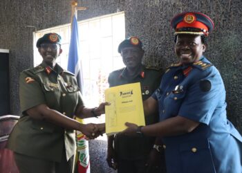 New DWA Brig Gen Charity Bainababo receiving office tools from outgoing Acting DWA Col. Lydia Nandudu during the hand over ceremony at MoDVA Mbuya