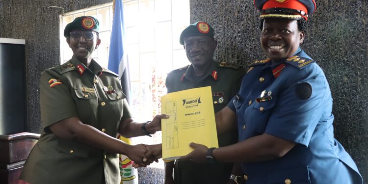New DWA Brig Gen Charity Bainababo receiving office tools from outgoing Acting DWA Col. Lydia Nandudu during the hand over ceremony at MoDVA Mbuya