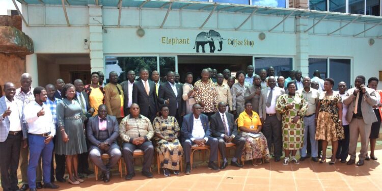 Hajji Kakande in a group photo with Office of the President officials and RDCs